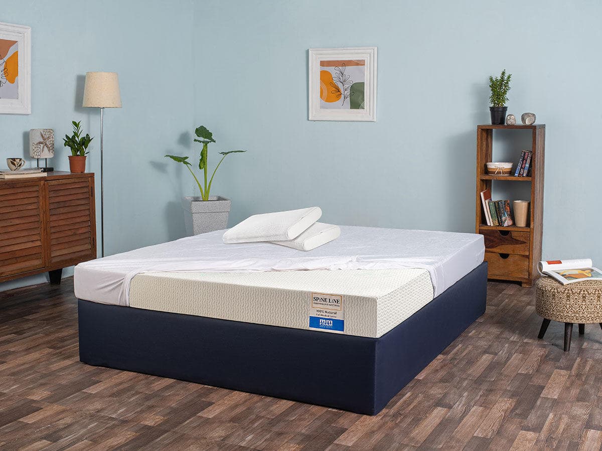 An MM Foam Spineline mattress with the cover turned back, showing the natural latex core underneath and the model label on the side panel