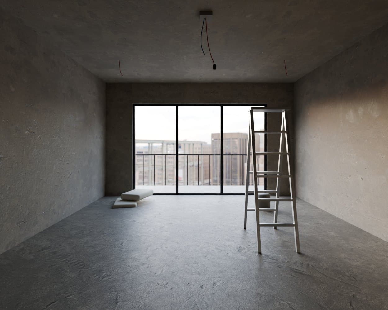 An empty living room in bare cement, with wires hanging from the ceiling and a ladder by the balcony door.