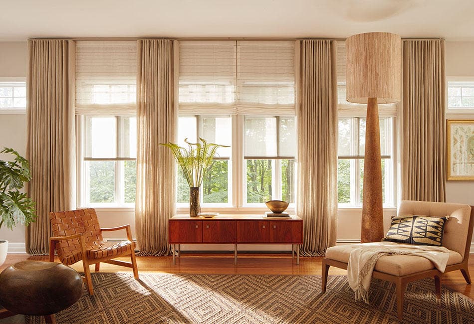 Curtains stacked back onto the wall with a shade on the glass, so the window still works when the fabric is open